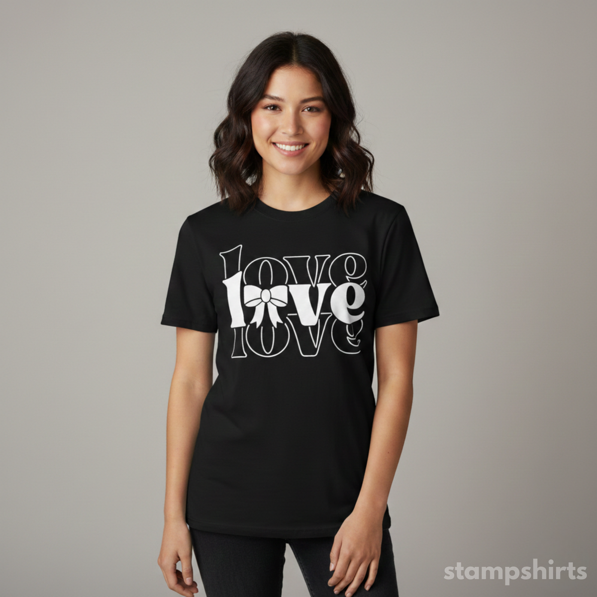 Person wearing a black t-shirt with 'LOVE' printed on it against a gray background