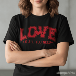 Person wearing a black t-shirt with red text 'LOVE IS ALL YOU NEED' on a plain background thumbnail 1