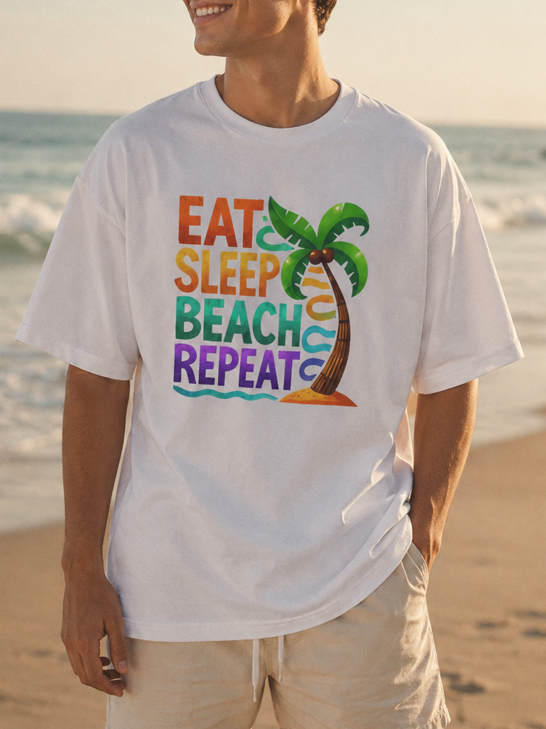 Man wearing a white t-shirt with 'Eat Sleep Beach Repeat' design on a beach.