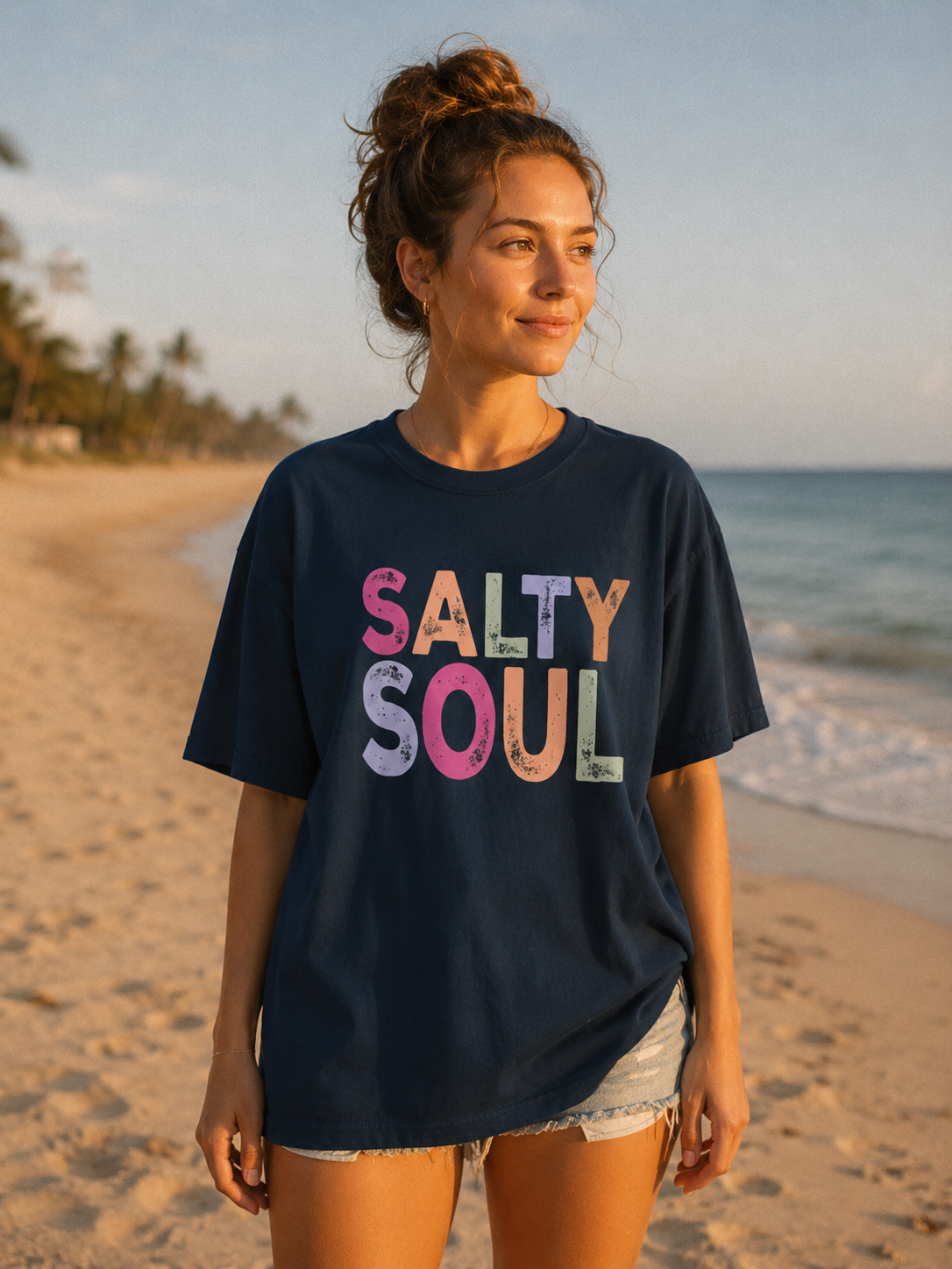 Woman wearing a navy blue t-shirt with 'Salty Soul' text on a beach