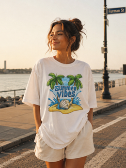 Woman wearing a 'Summer Vibes' t-shirt by the waterfront thumbnail 2