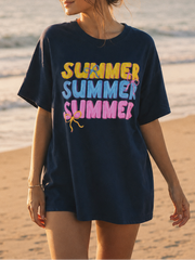 Woman wearing a navy blue t-shirt with 'SUMMER SUMMER SUMMER' text on a beach.