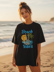 Woman wearing a black t-shirt with 'Beach Vibes' design on a beach