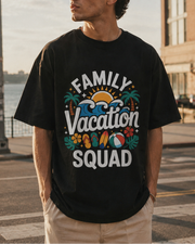 Man wearing a black t-shirt with 'Family Vacation Squad' design by a waterfront.
