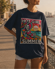 Woman wearing a 'Hot Girl Summer' t-shirt by a waterfront with a city skyline in the background.