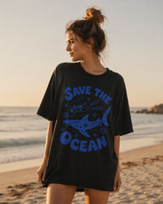 Woman wearing a 'Save the Ocean' t-shirt on a beach