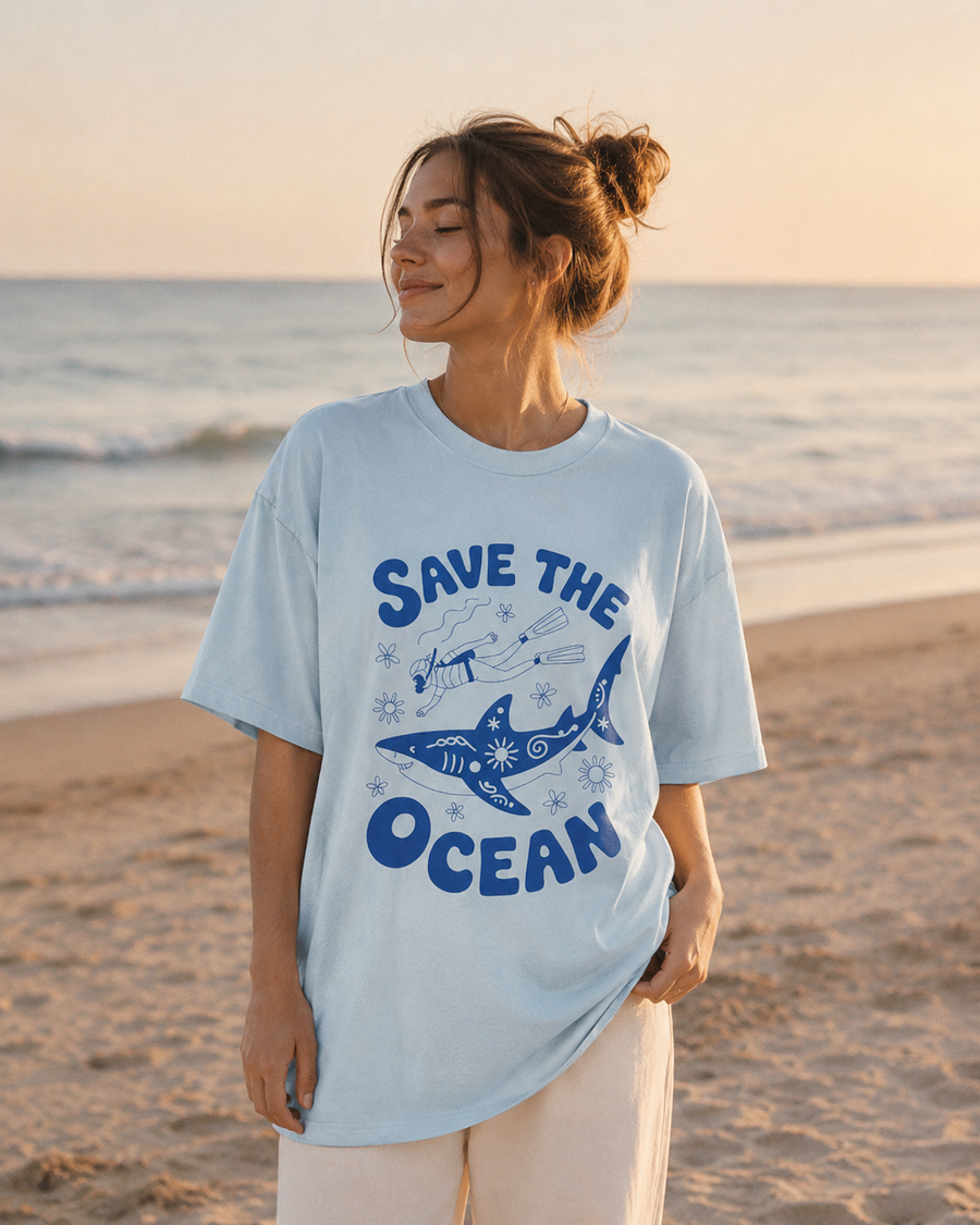 Person wearing a 'Save the Ocean' t-shirt on a beach