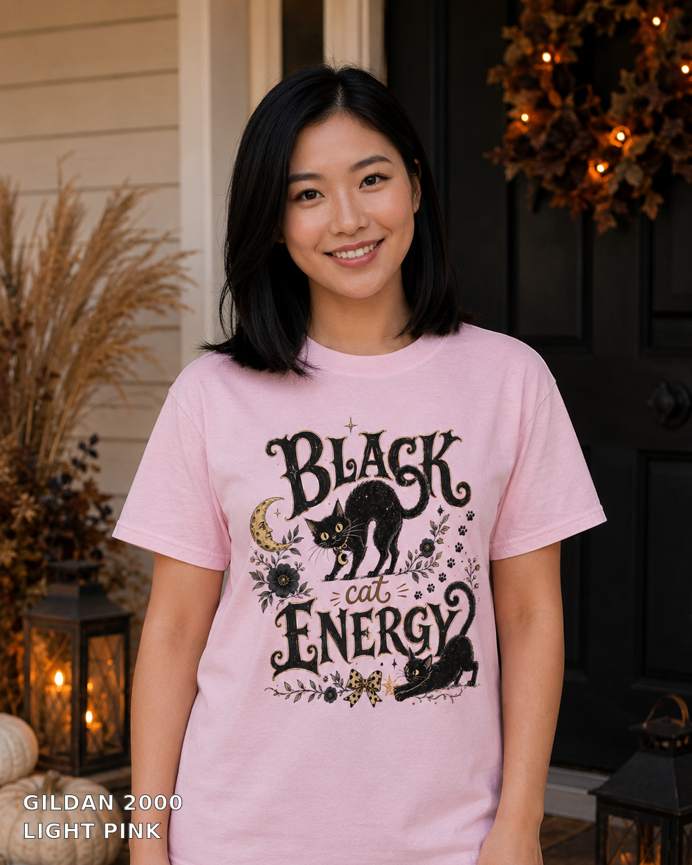 Black Cat Energy Vintage Halloween T-Shirt — Gildan 2000 Light Pink — female model