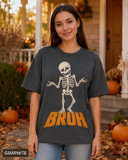 Female model wearing Graphite BRUH shrugging skeleton Halloween T-shirt