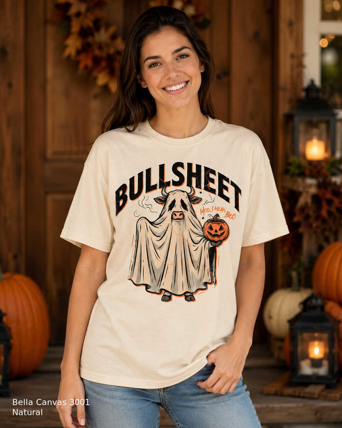 Female model wearing the Bella Canvas 3001 Natural Bullsheet Ghost Cow Halloween T-shirt