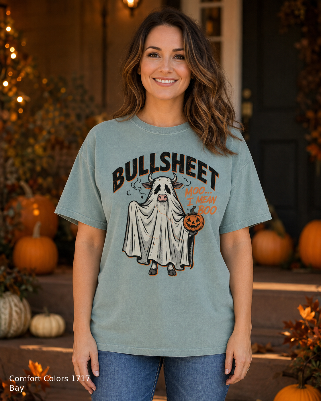 Female model wearing the Comfort Colors 1717 Bay Bullsheet Ghost Cow Halloween T-shirt