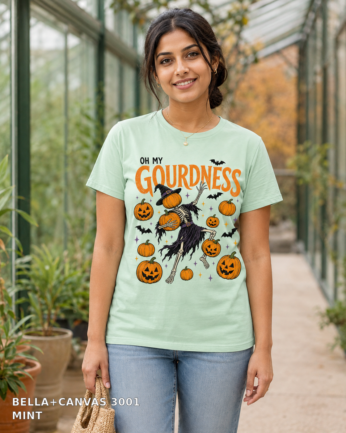 Female model wearing Oh My Gourdness Halloween skeleton T-shirt - Bella+Canvas 3001 - Mint