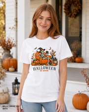 Female model wearing the Bella Canvas 3001 White Halloween Is Good skeleton pumpkin chair T-shirt