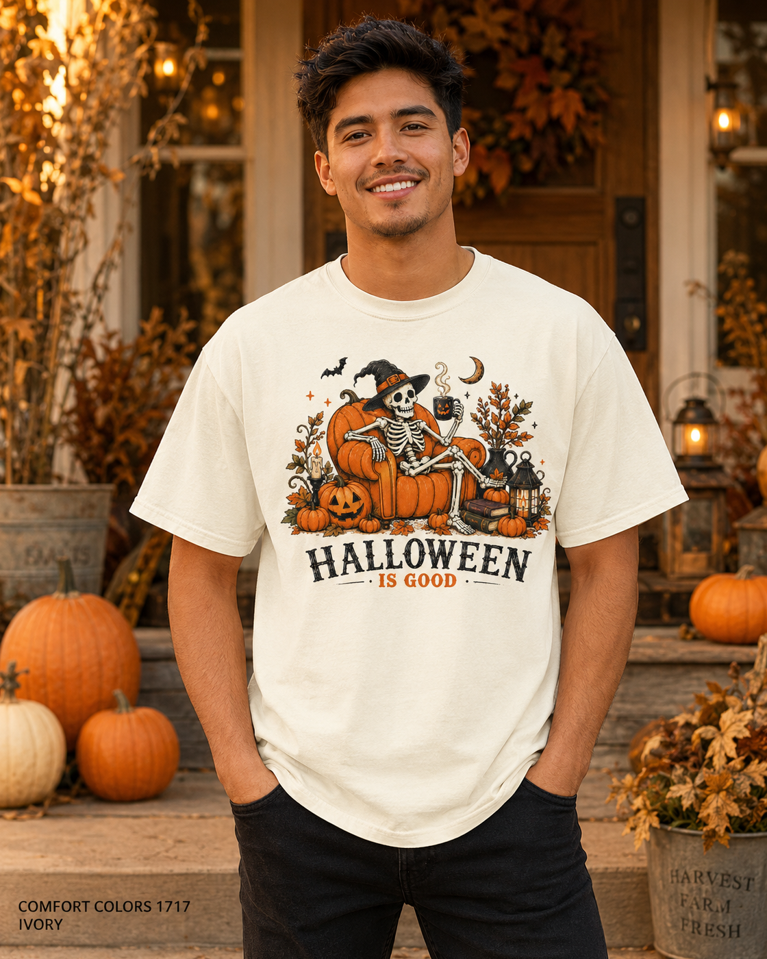 Male model wearing the Comfort Colors 1717 Ivory Halloween Is Good skeleton pumpkin chair T-shirt