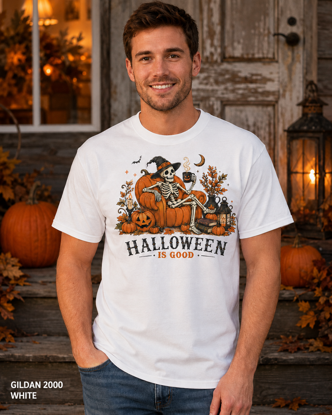Male model wearing the Gildan 2000 White Halloween Is Good skeleton pumpkin chair T-shirt