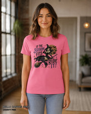 Female model wearing Bella Canvas 3001 Charity Pink If the Broom Fits Ride It witch T-shirt with corrected Printify-matched print scale