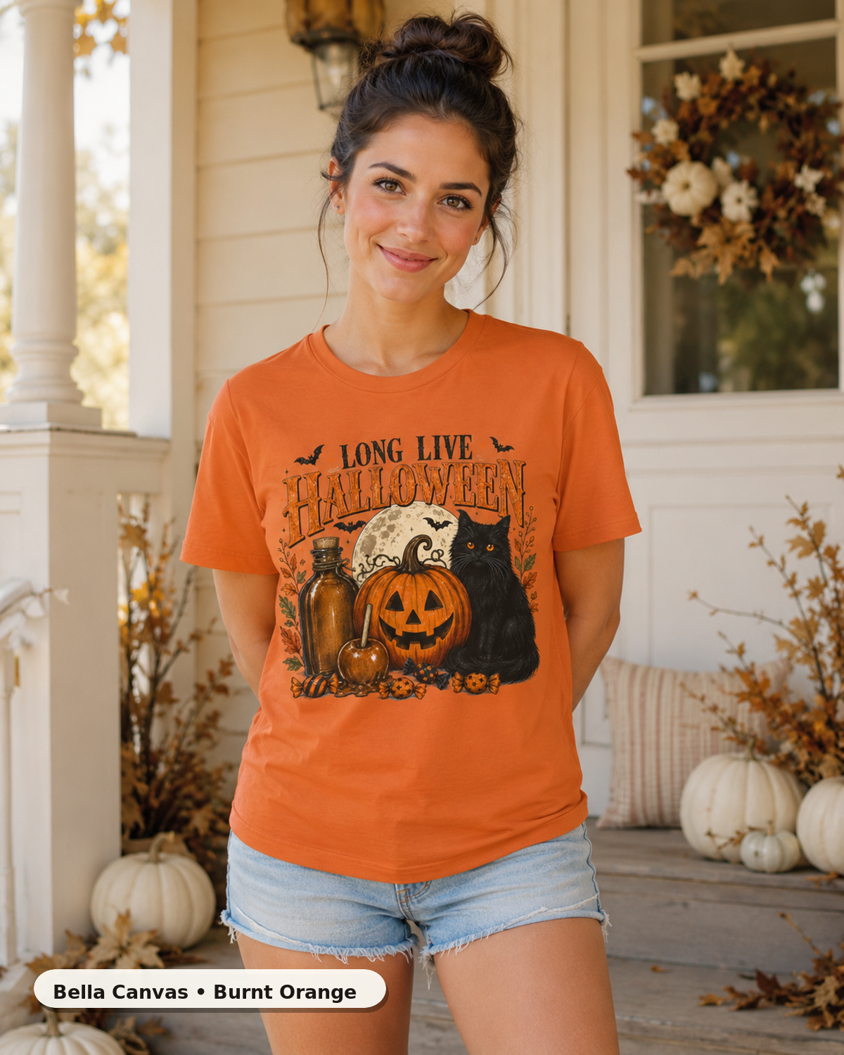 Female model wearing Long Live Halloween black cat and pumpkin T-shirt in Bella Canvas Burnt Orange