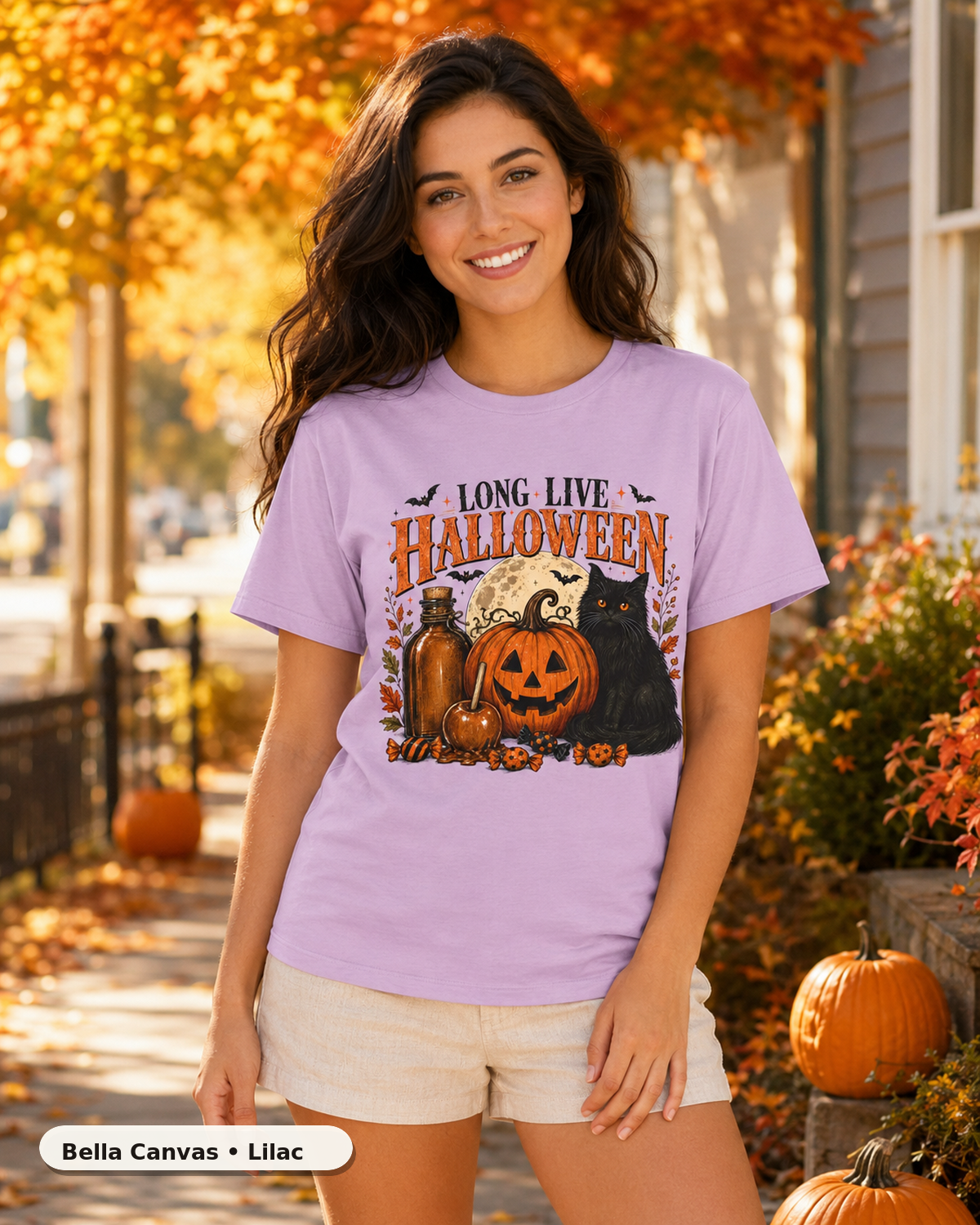 Female model wearing Long Live Halloween black cat and pumpkin T-shirt in Bella Canvas Lilac
