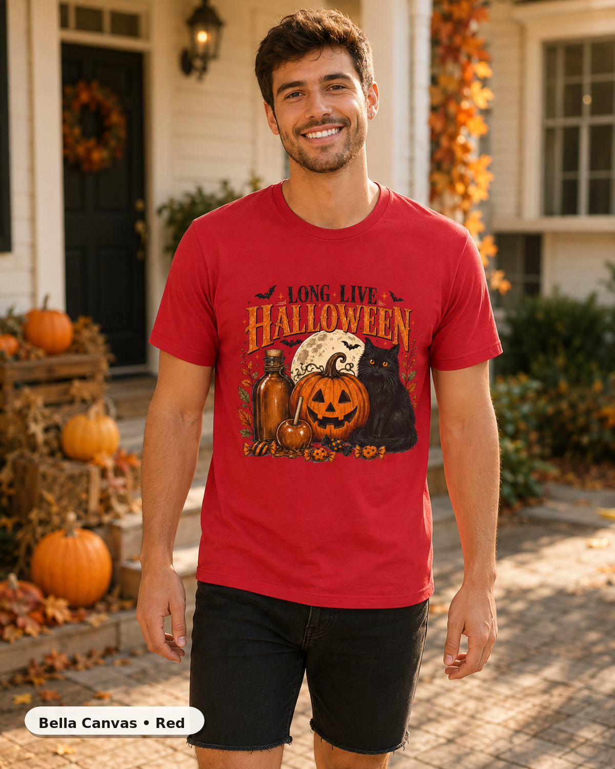 Male model wearing Long Live Halloween black cat and pumpkin T-shirt in Bella Canvas Red