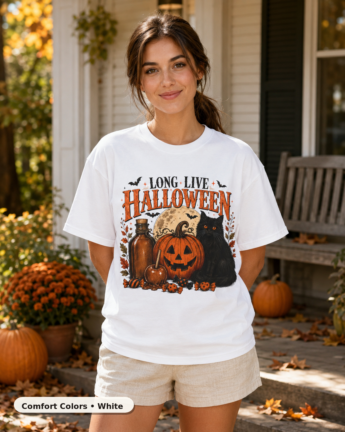 Female model wearing Long Live Halloween black cat and pumpkin T-shirt in Comfort Colors White