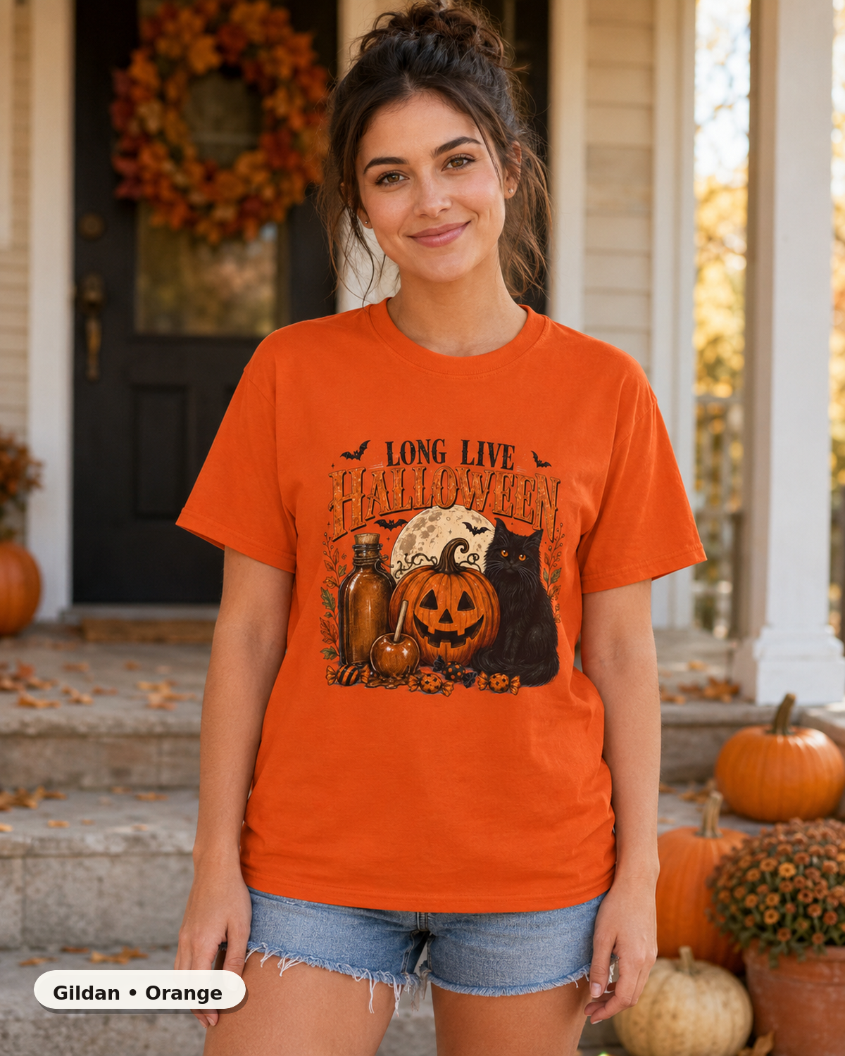Female model wearing Long Live Halloween black cat and pumpkin T-shirt in Gildan Orange