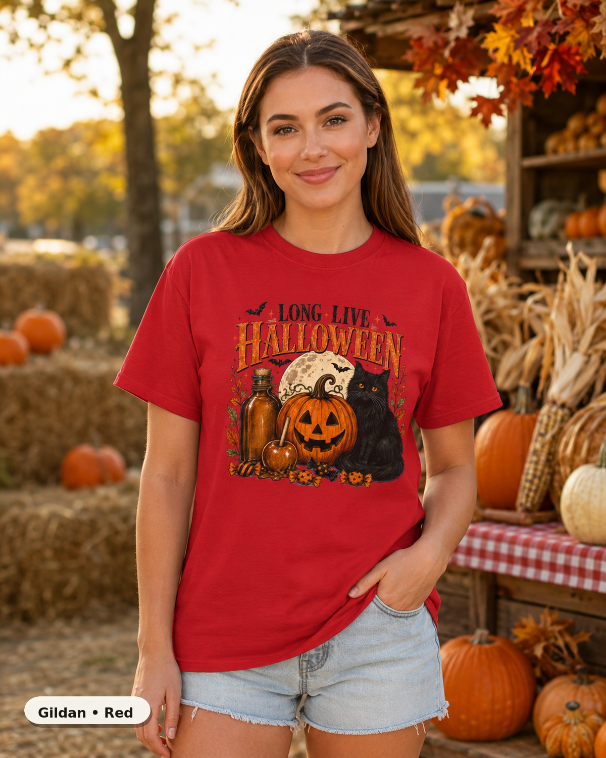 Female model wearing Long Live Halloween black cat and pumpkin T-shirt in Gildan Red