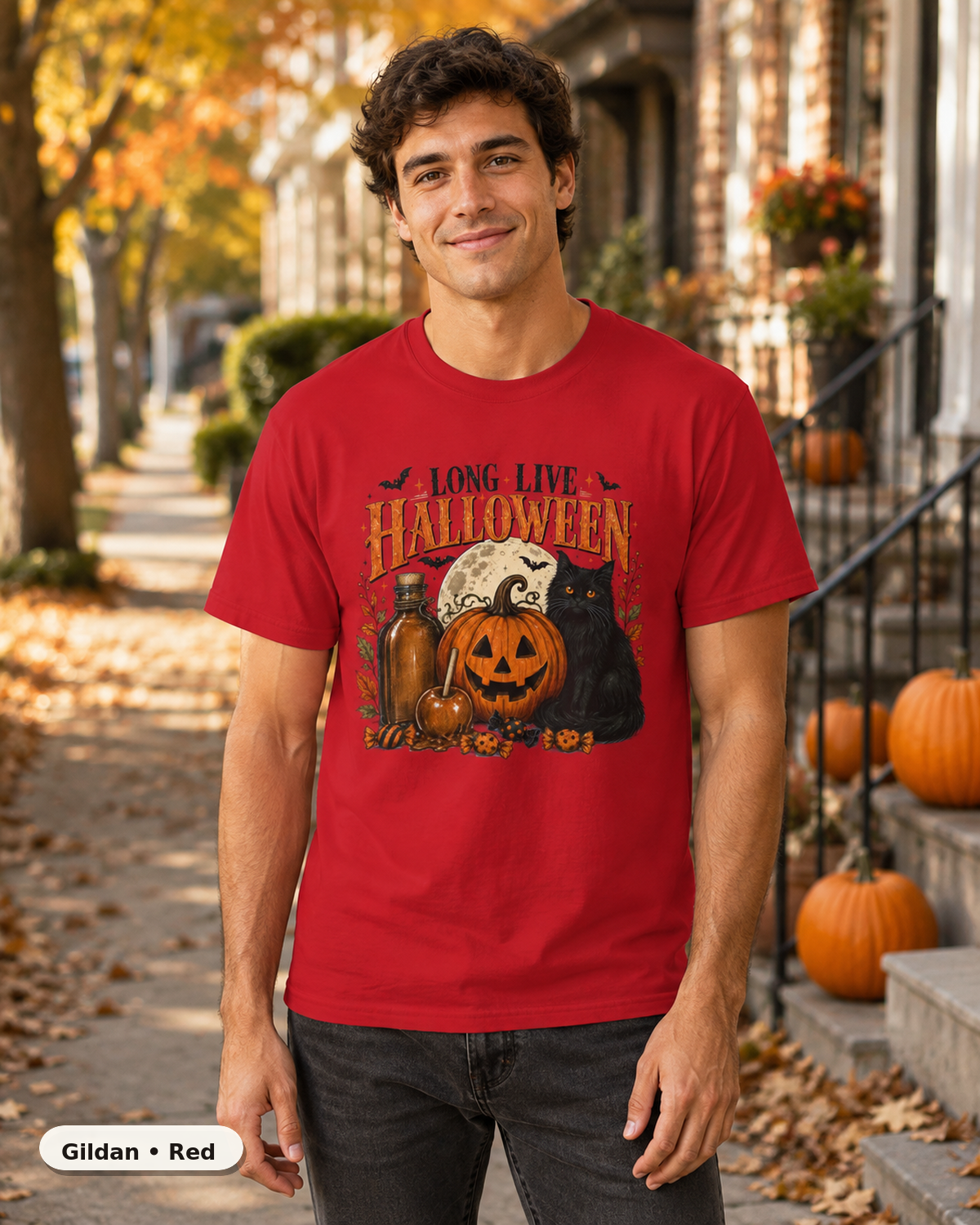 Male model wearing Long Live Halloween black cat and pumpkin T-shirt in Gildan Red