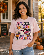 Female model wearing You Can't Scare Me I'm a Teacher Halloween T-shirt - Comfort Colors 1717 - Blossom