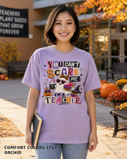 Female model wearing You Can't Scare Me I'm a Teacher Halloween T-shirt - Comfort Colors 1717 - Orchid