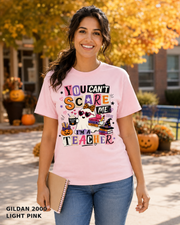 Female model wearing You Can't Scare Me I'm a Teacher Halloween T-shirt - Gildan 2000 - Light Pink