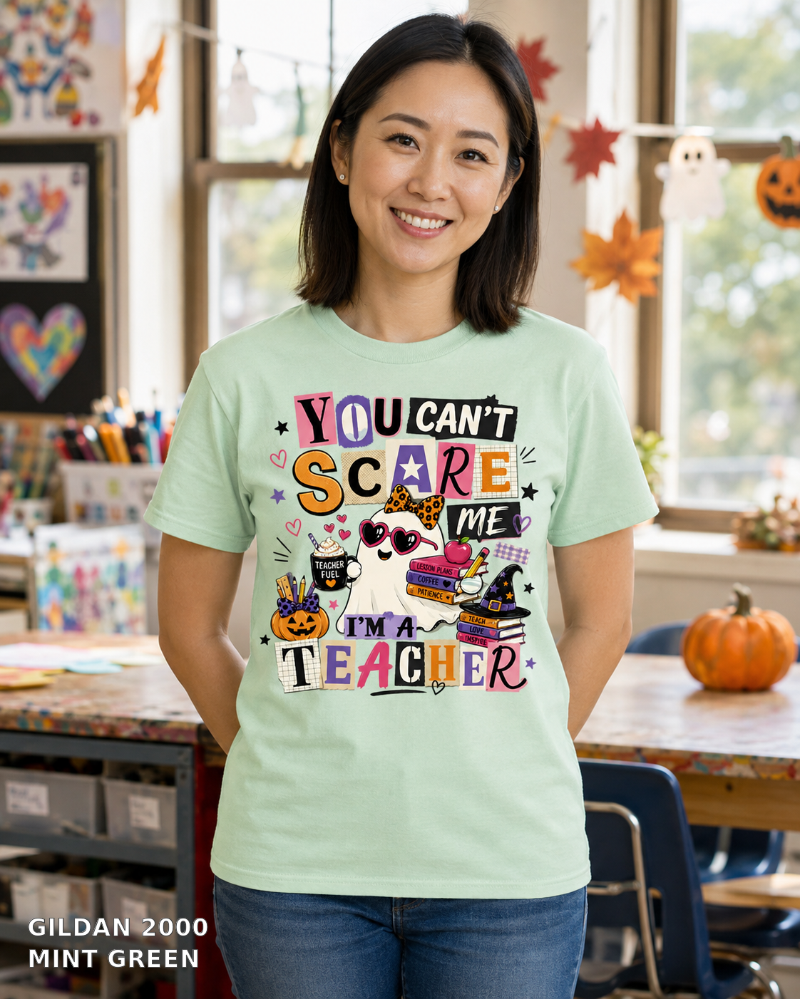Female model wearing You Can't Scare Me I'm a Teacher Halloween T-shirt - Gildan 2000 - Mint Green
