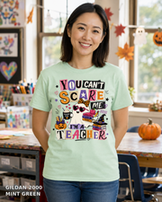 Female model wearing You Can't Scare Me I'm a Teacher Halloween T-shirt - Gildan 2000 - Mint Green