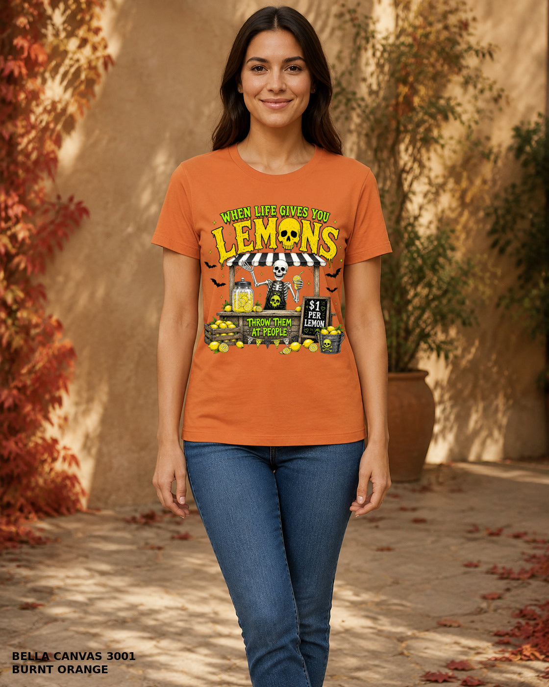 Female model wearing Bella Canvas 3001 Burnt Orange When Life Gives You Lemons skeleton Halloween T-shirt, corrected artwork