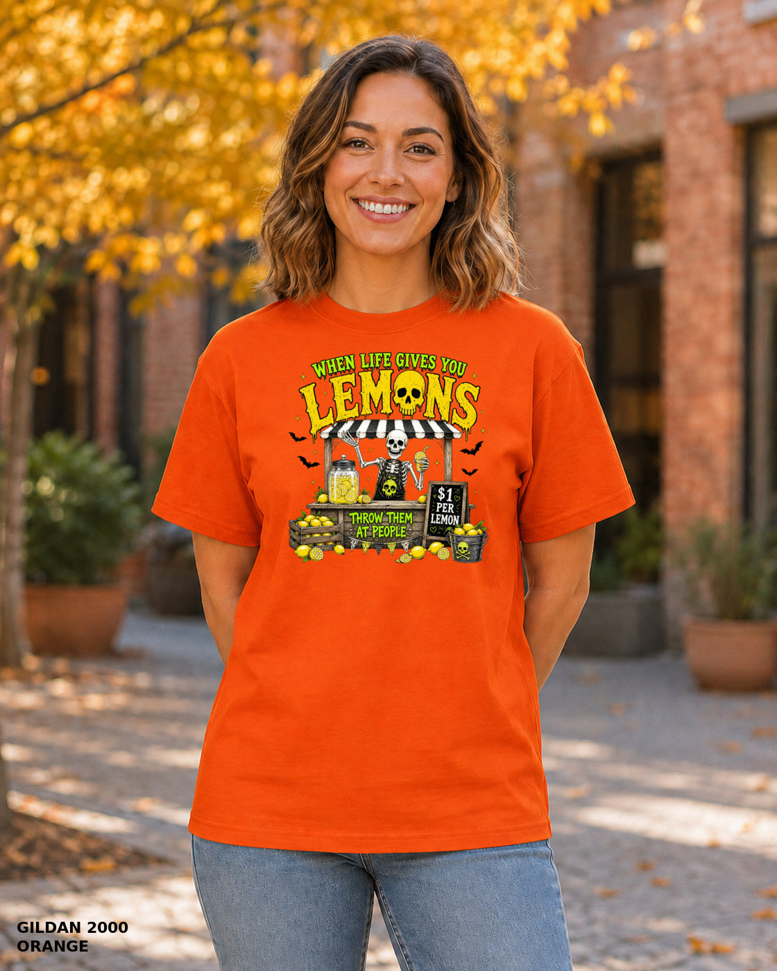 Female model wearing Gildan 2000 Orange When Life Gives You Lemons skeleton Halloween T-shirt, corrected artwork