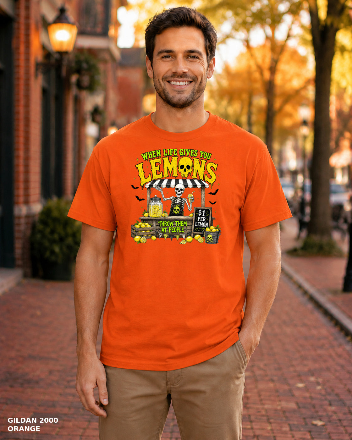Male model wearing Gildan 2000 Orange When Life Gives You Lemons skeleton Halloween T-shirt, corrected artwork