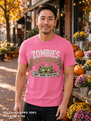 Male model wearing the Bella Canvas 3001 Charity Pink Zombies Eat Brains funny Halloween T-shirt
