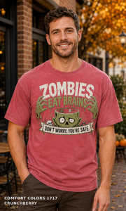 Male model wearing the Comfort Colors 1717 Crunchberry Zombies Eat Brains funny Halloween T-shirt