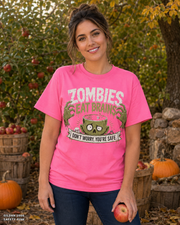 Female model wearing the Gildan 2000 Safety Pink Zombies Eat Brains funny Halloween T-shirt