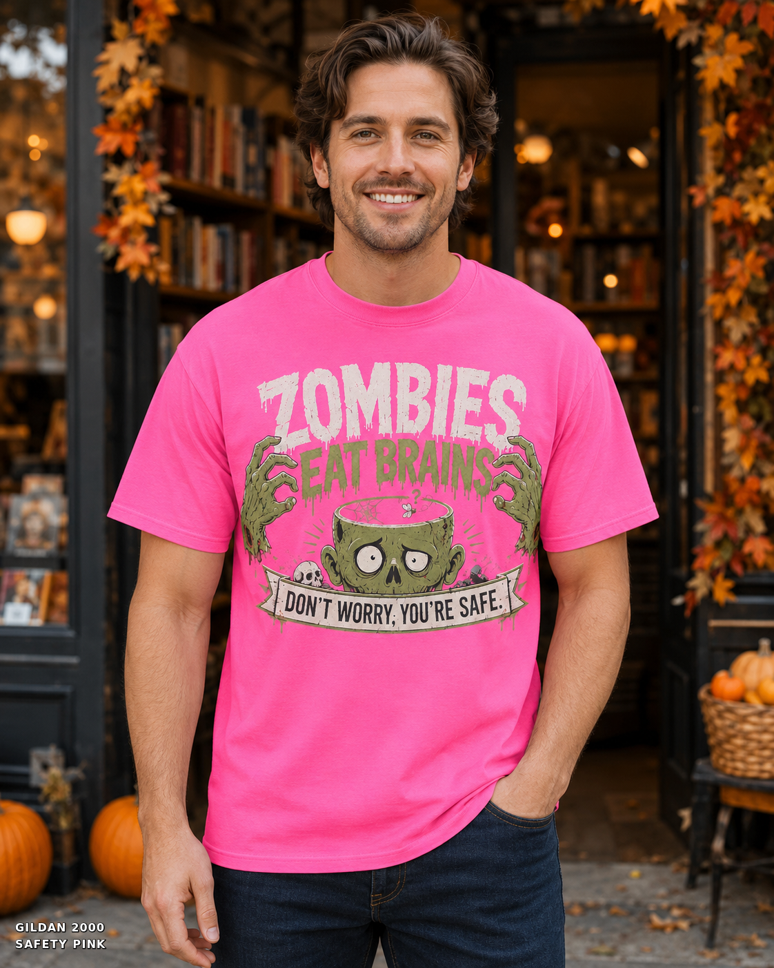 Male model wearing the Gildan 2000 Safety Pink Zombies Eat Brains funny Halloween T-shirt
