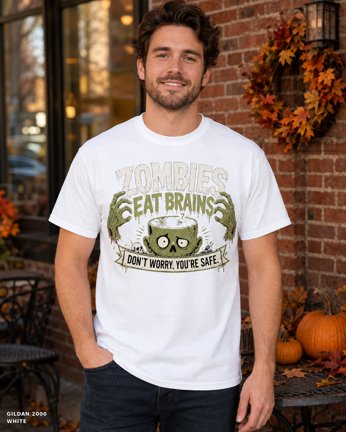 Male model wearing the Gildan 2000 White Zombies Eat Brains funny Halloween T-shirt