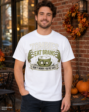 Male model wearing the Gildan 2000 White Zombies Eat Brains funny Halloween T-shirt